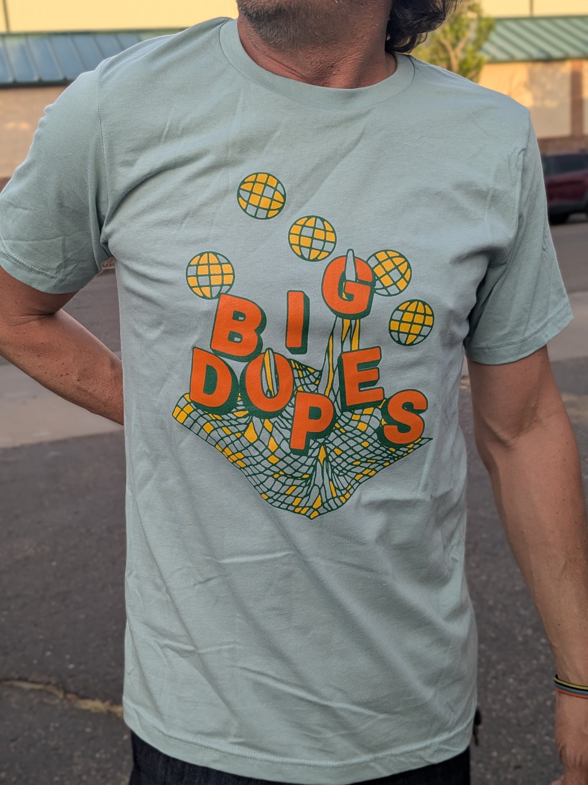 Model showing off Big Dopes geoform shirt in dusty blue